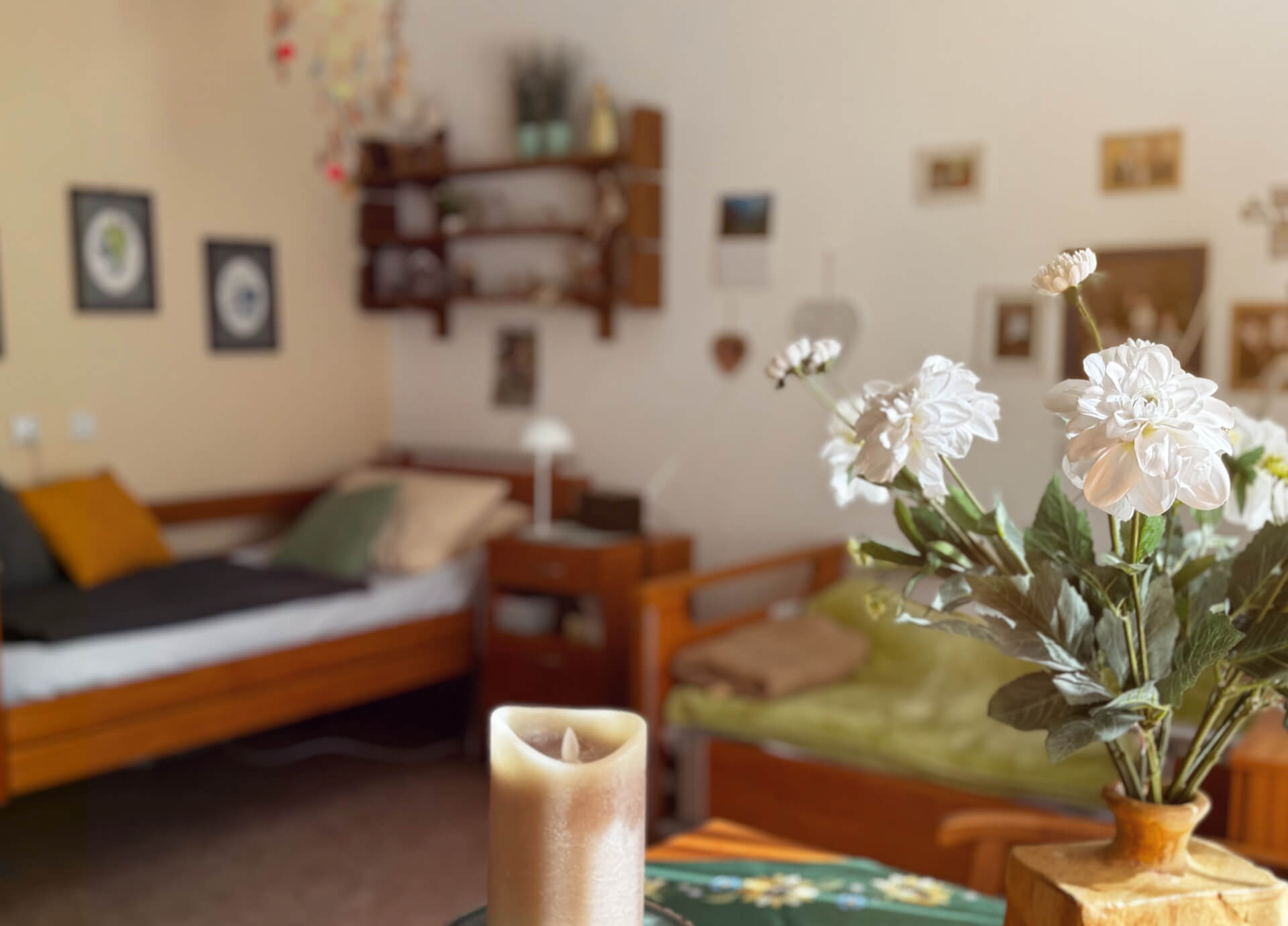 Ein Zimmer mit Bett, Couch, Tisch und frischen Blumen